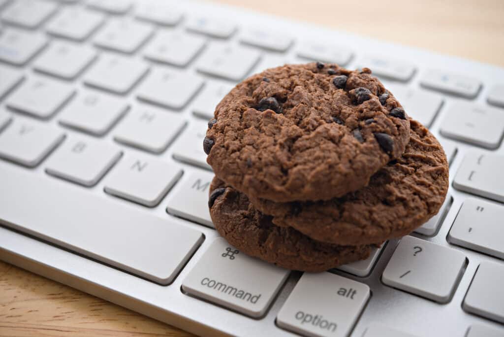 Chocolate chip cookies resting on a computer keyboard