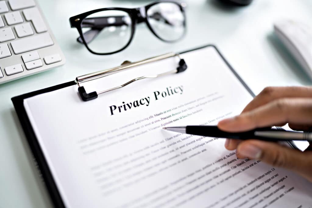 Closeup of privacy policy document with pen and glasses