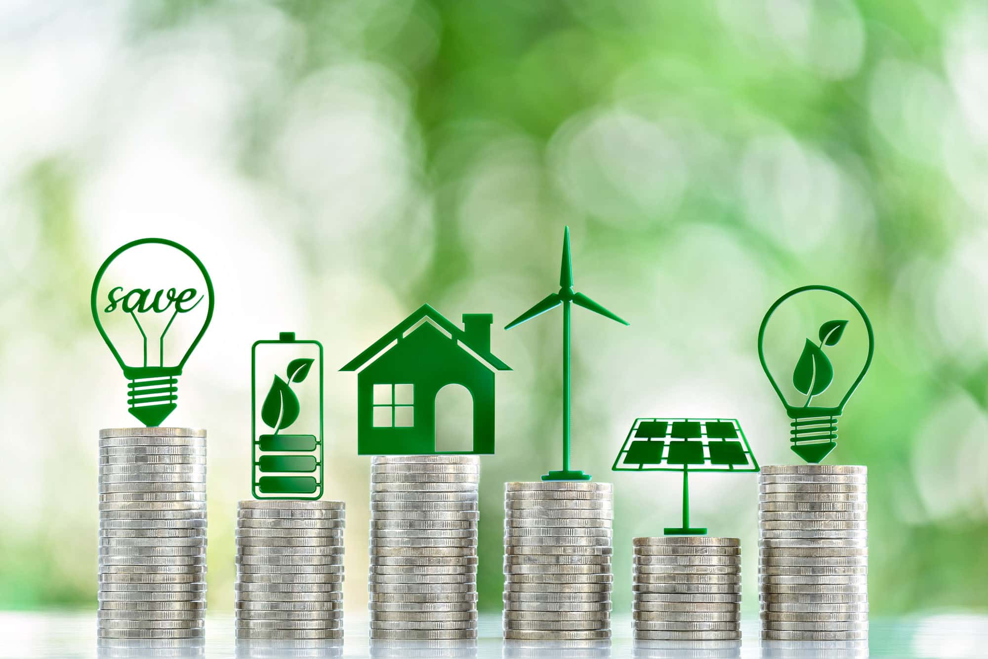 Energy savings concept with stacked coins and green energy icons