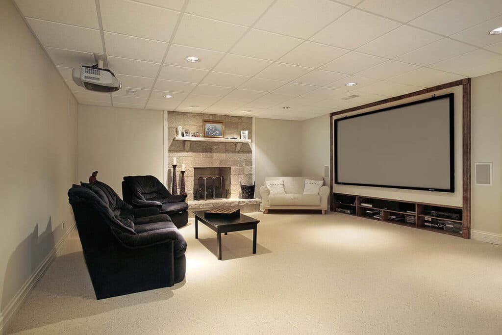Modern home theatre room with large screen and cozy seating