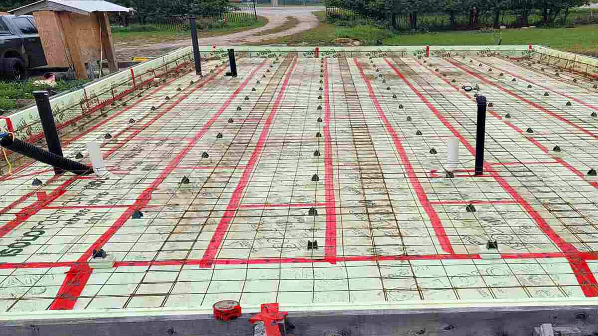 Prepared concrete slab with plumbing pipes for construction