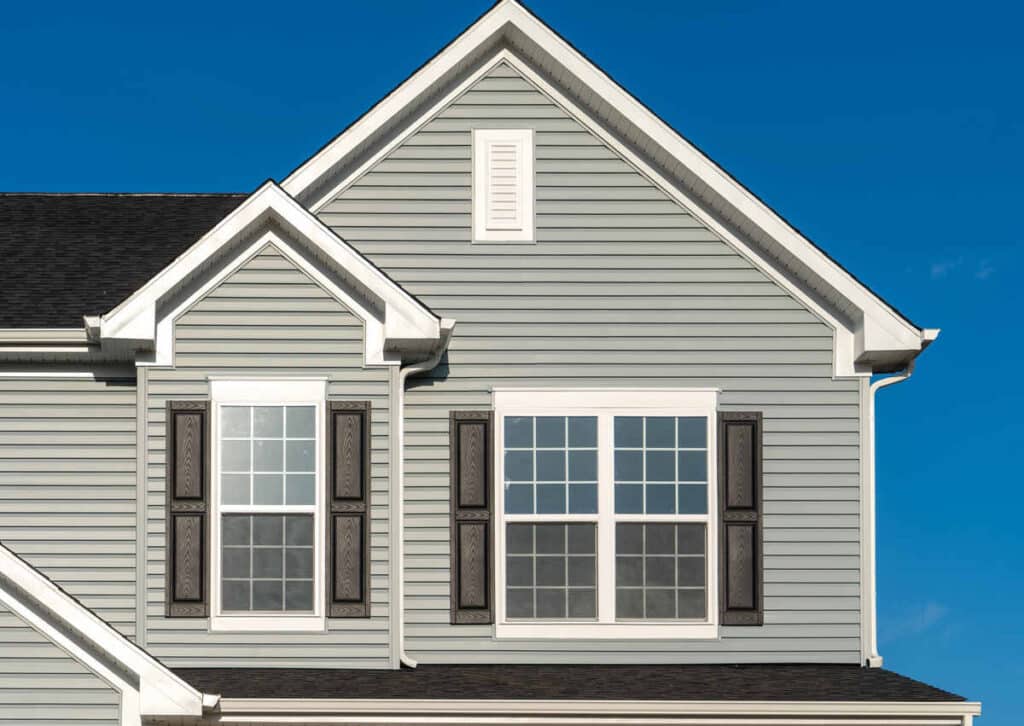 Modern two-storey grey house with white trim and shutters