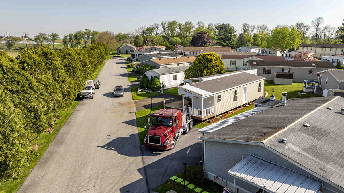 Aerial view of mobile home park with transport trucks