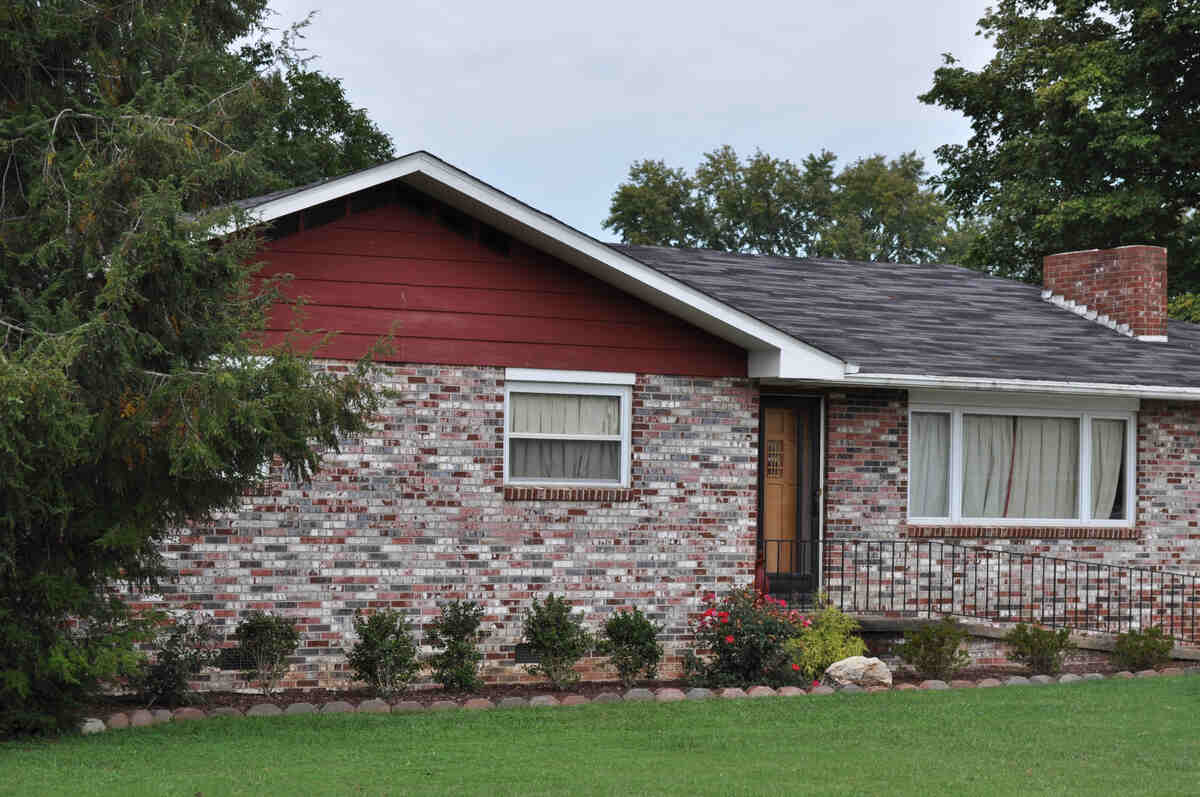 Single-storey brick house with front garden and red gable