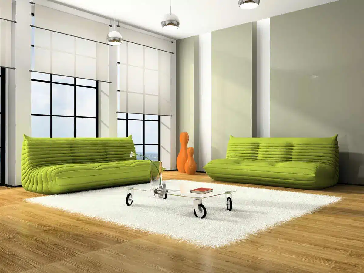 Modern living room with green sofas and wooden floor