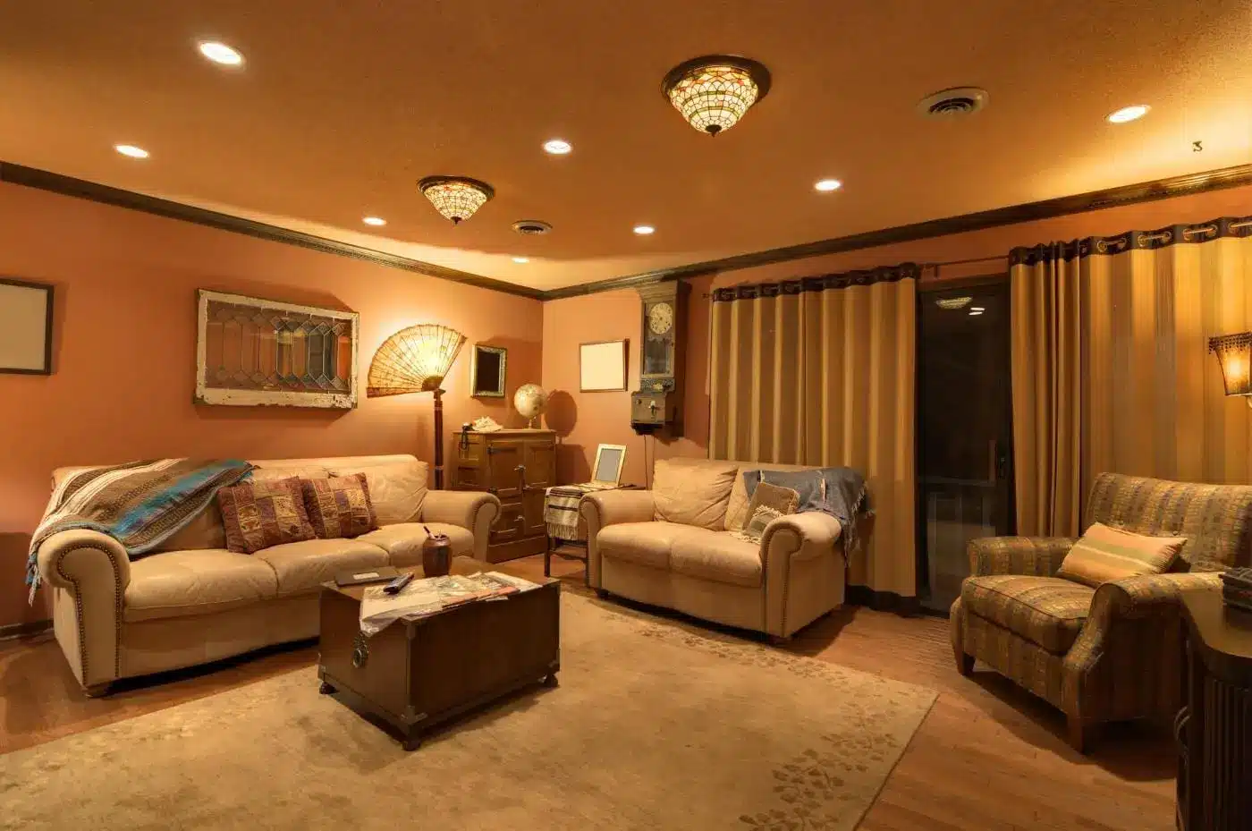 Cozy living room with beige sofas and warm lighting, featuring vintage decor