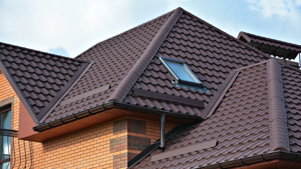 Modern house with brown metal roof tiles and a skylight