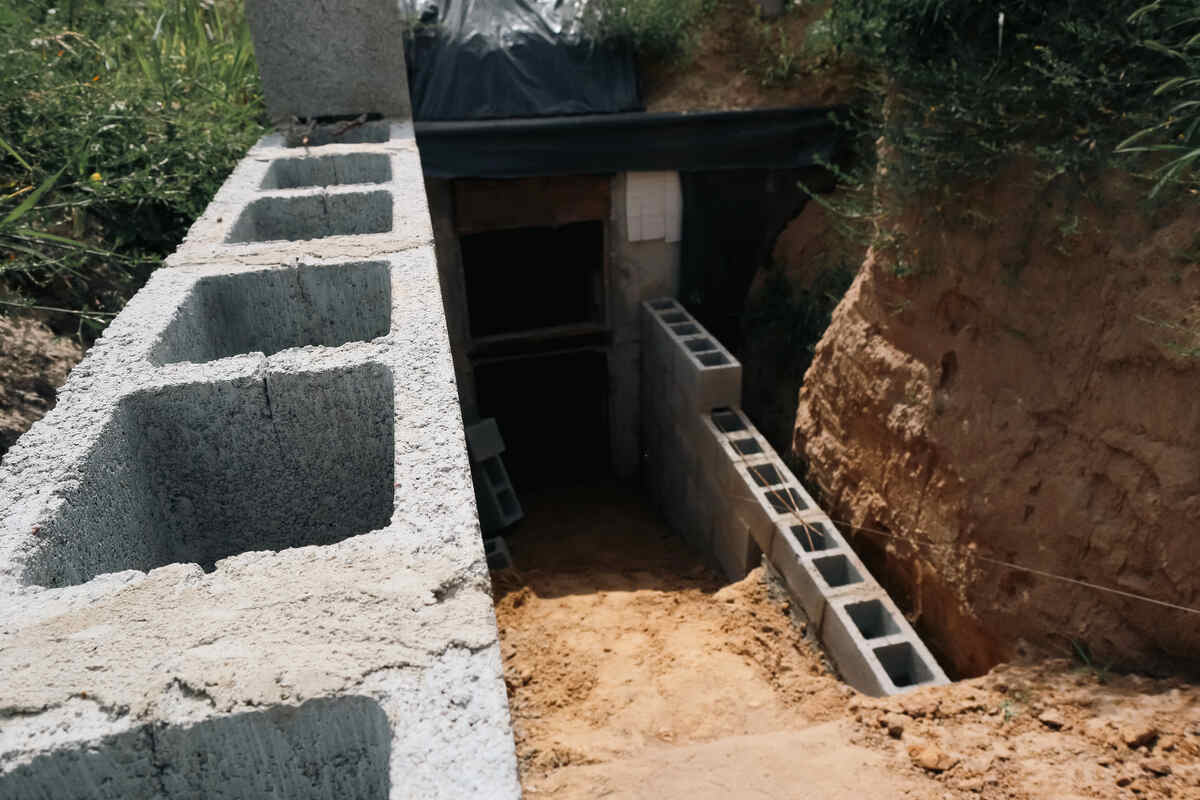 Concrete bunker entrance under construction with cinder blocks
