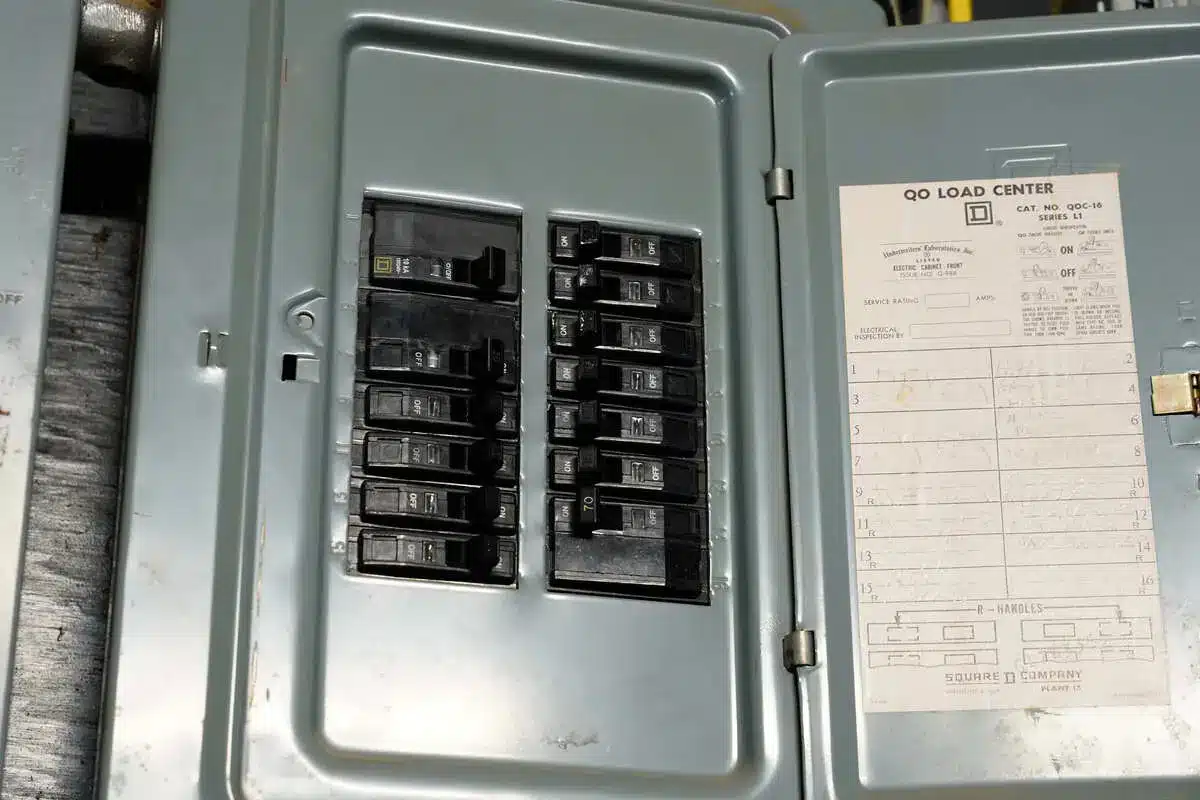 Electrical panel with open cover showing circuit breakers in a residential home