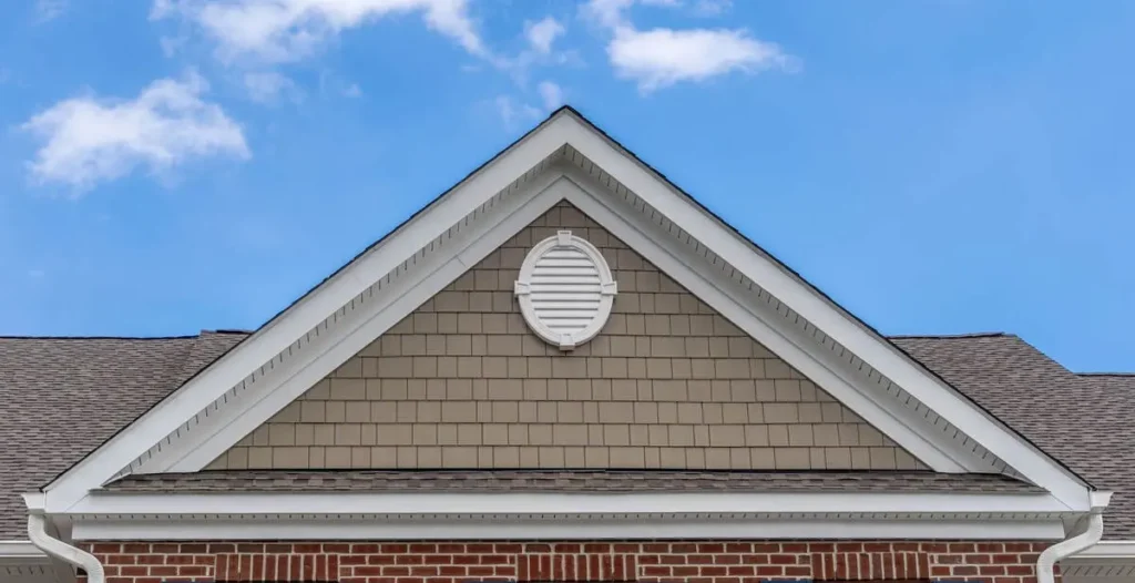 Detailed gable on a residential roof under clear sky